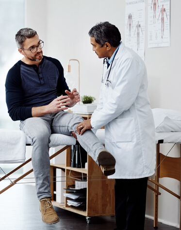 doctor talking to patient about knee pain 