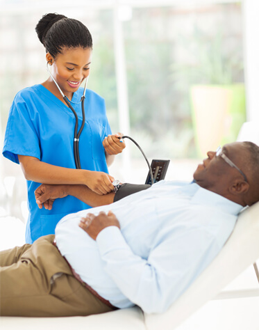 nurse taking patient's blood pressure