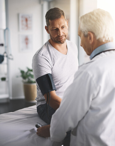 a doctor taking patient's blood pressure 