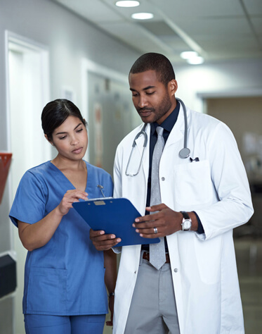 doctor and nurse looking at a chart